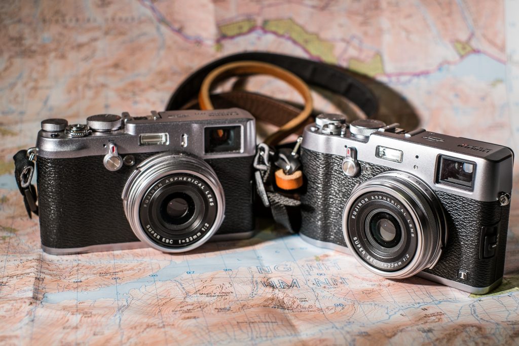 Fujifilm X100 and X100T sitting side by side on a map.