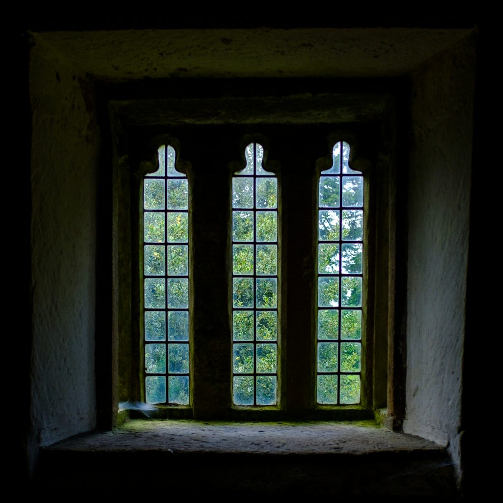Three panel window in room above the porch at St. Andrews Church, Stoke Dry, Rutland.